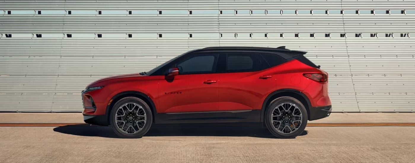 A red 2023 used Chevy Blazer parked against a wall