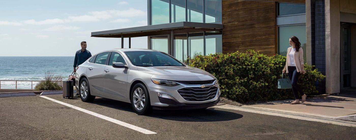 Silver 2024 Chevy Malibu parked near an ocean