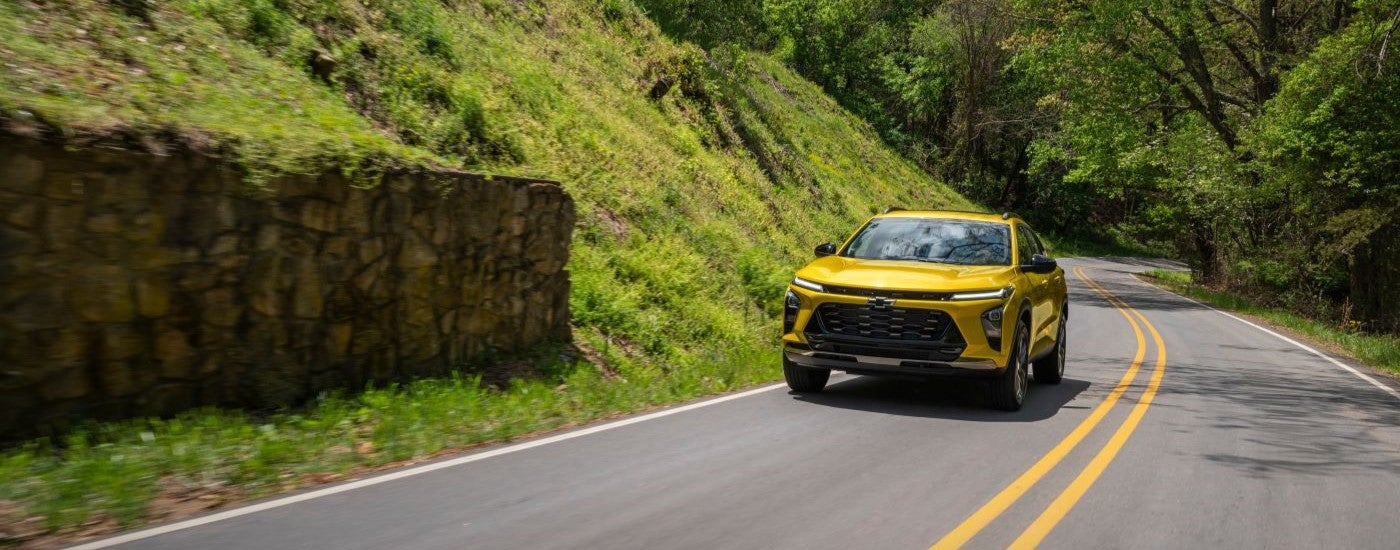 Yellow 2025 Chevy Trax ACTIV driving on a highway