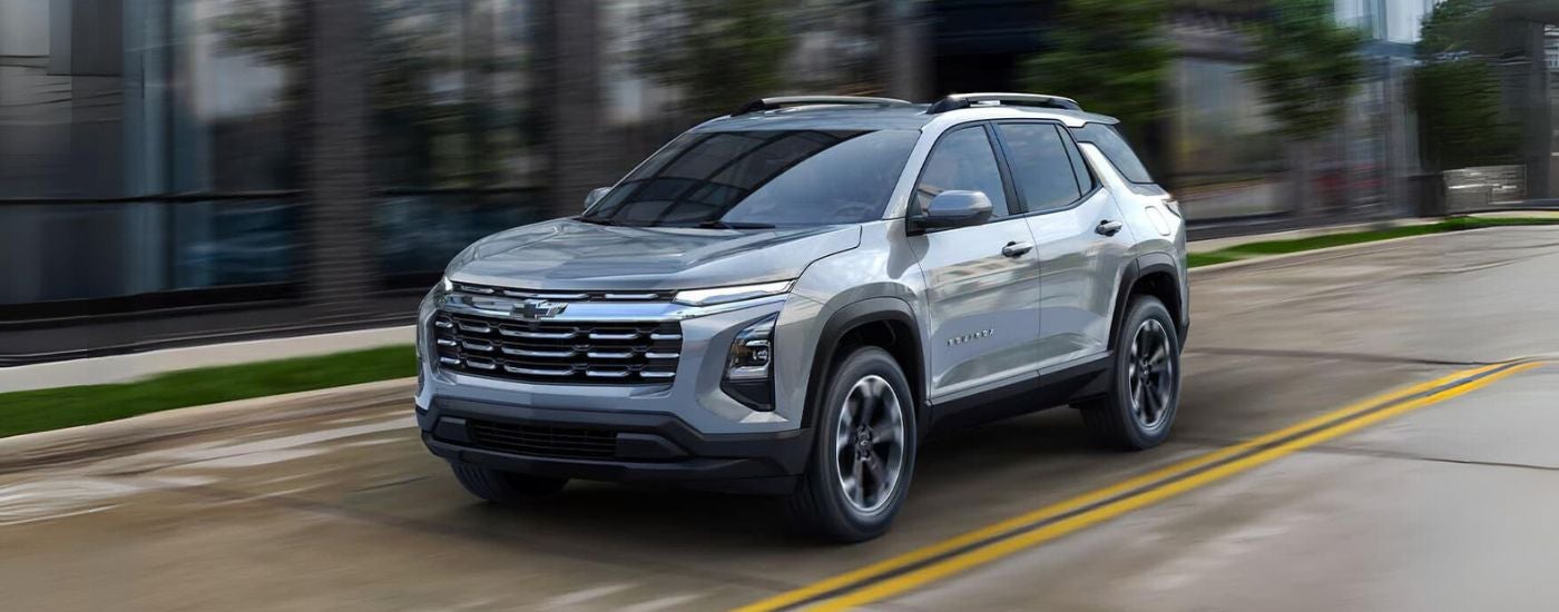Silver 2025 Chevy Equinox driving through a city