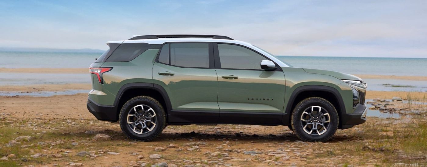 Green 2025 Chevy Equinox parked near water