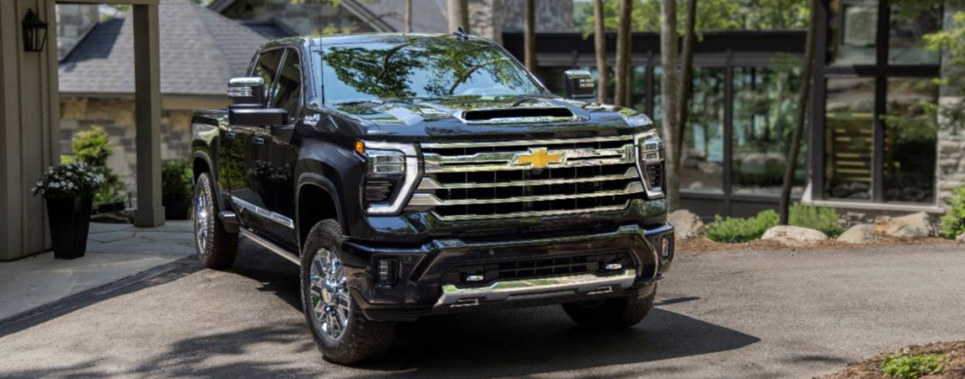 Black 2026 Chevy Silverado 2500 HD parked in front of a house