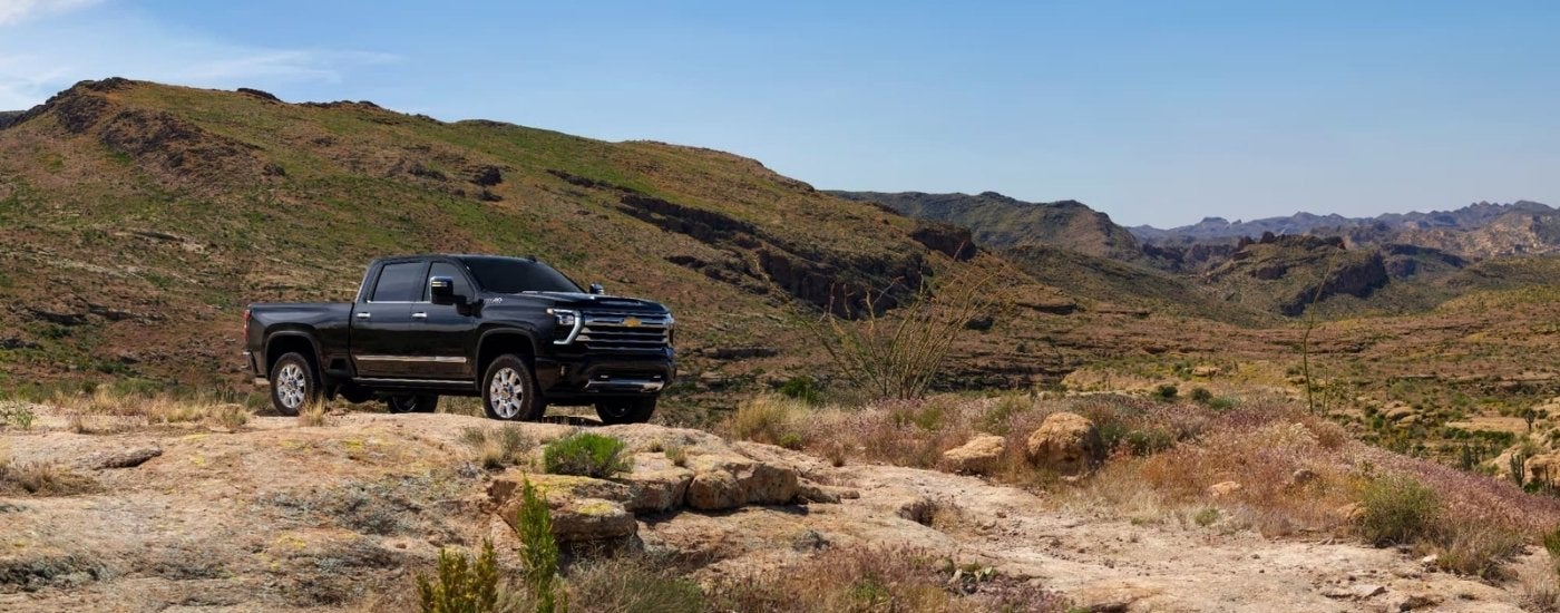 Black 2025 Chevy Silverado 2500 parked off-road