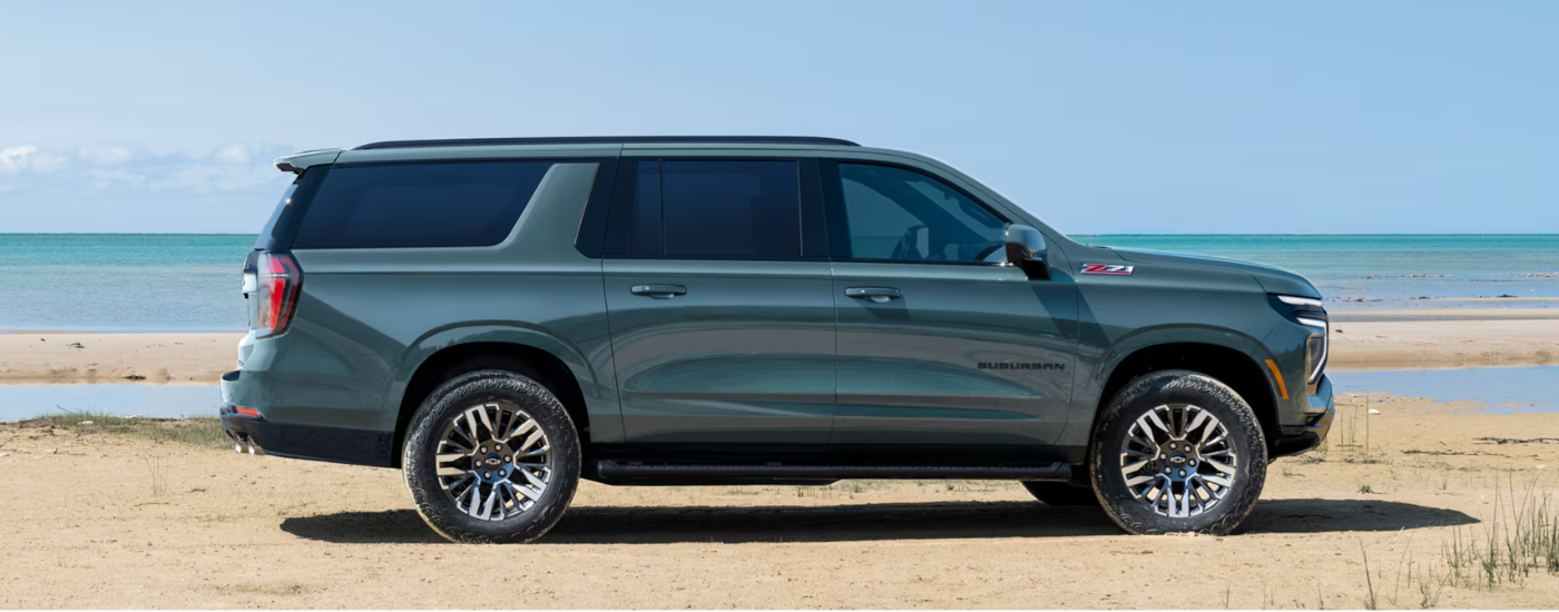 Blue 2026 Chevy Suburban Z71 driving along a beach
