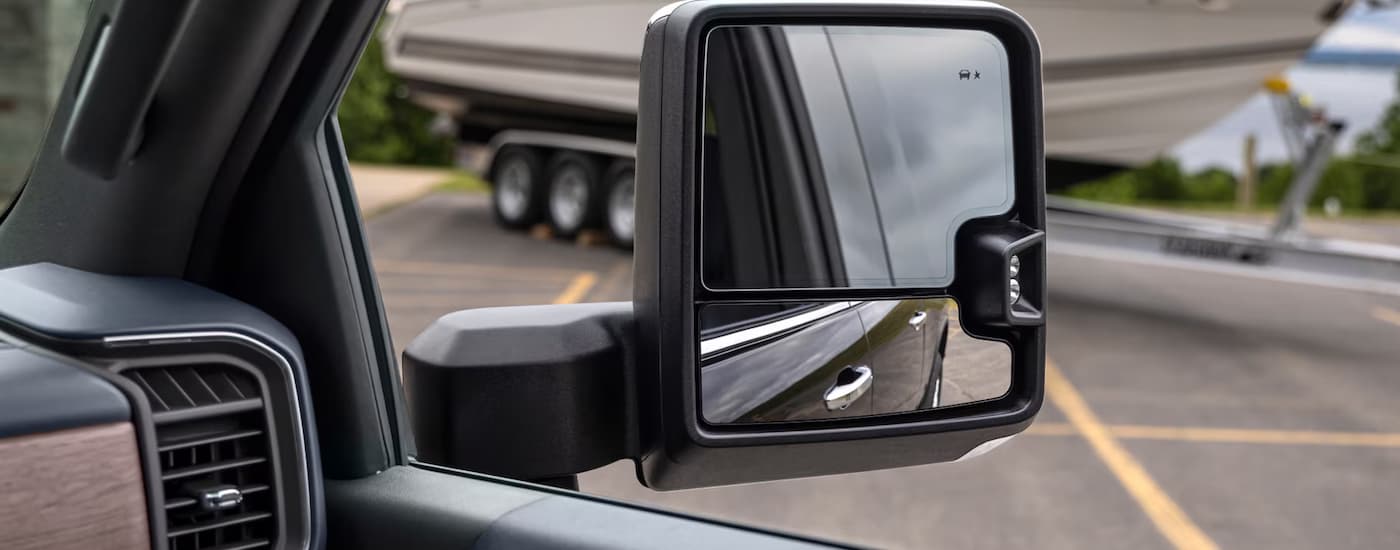 Side mirror on a black 2025 Chevy Silverado 2500HD.