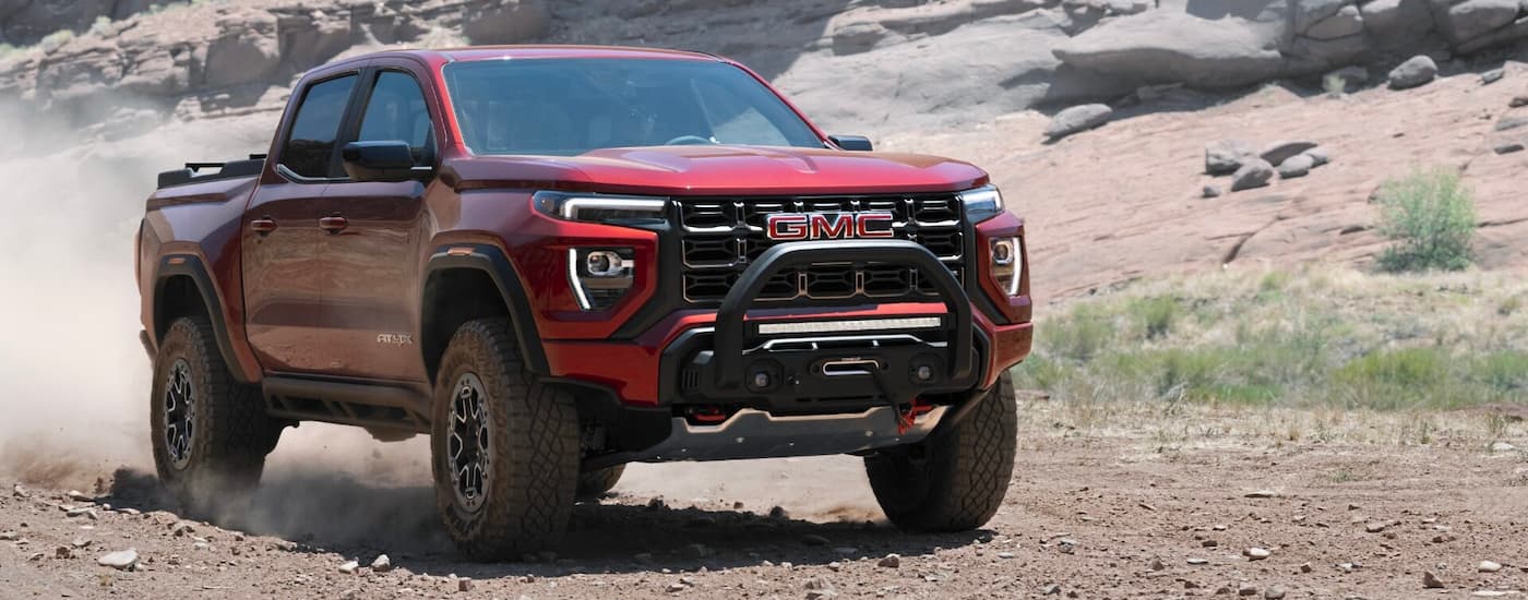 Red 2025 GMC Canyon AT4X for sale driving off-road.